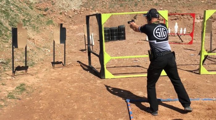 Max Michel aims pistol in competition