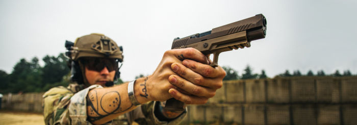 Man aims SIG SAUER M17 pistol