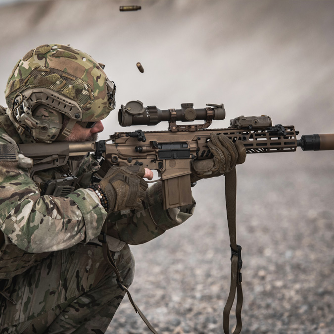Demonstration of the use of SIG SAUER tactical scopes with a shooter in full tactical gear spotting through AR 15 sights.