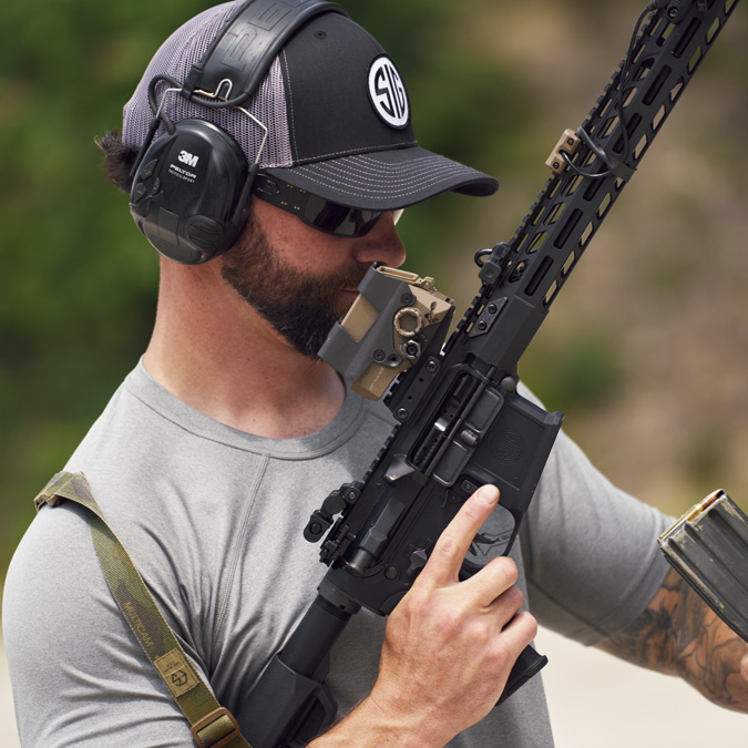 A rifle shooter demonstrating tactical ops with AR sights.
