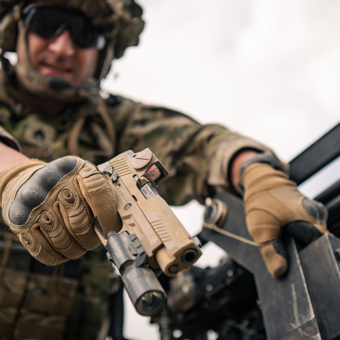 A shooter at the shooting range using the SIG SAUER Romeo red dot sight and demonstrating the use of weapon scopes & sights.