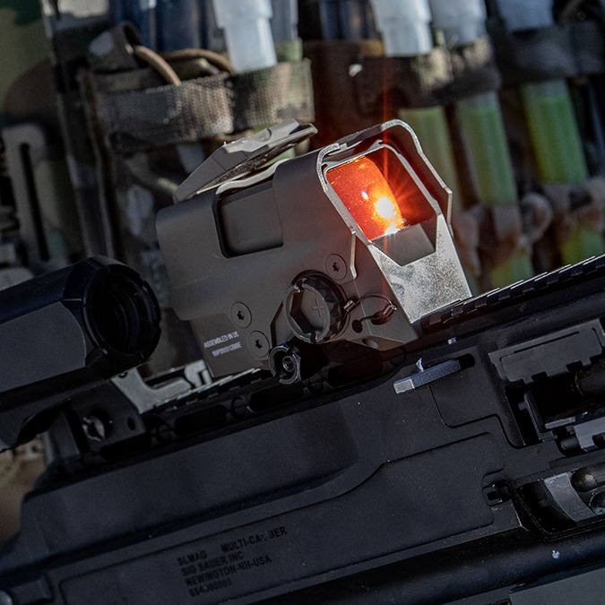 Optical sight mounted on a weapon to enhance shooter accuracy.